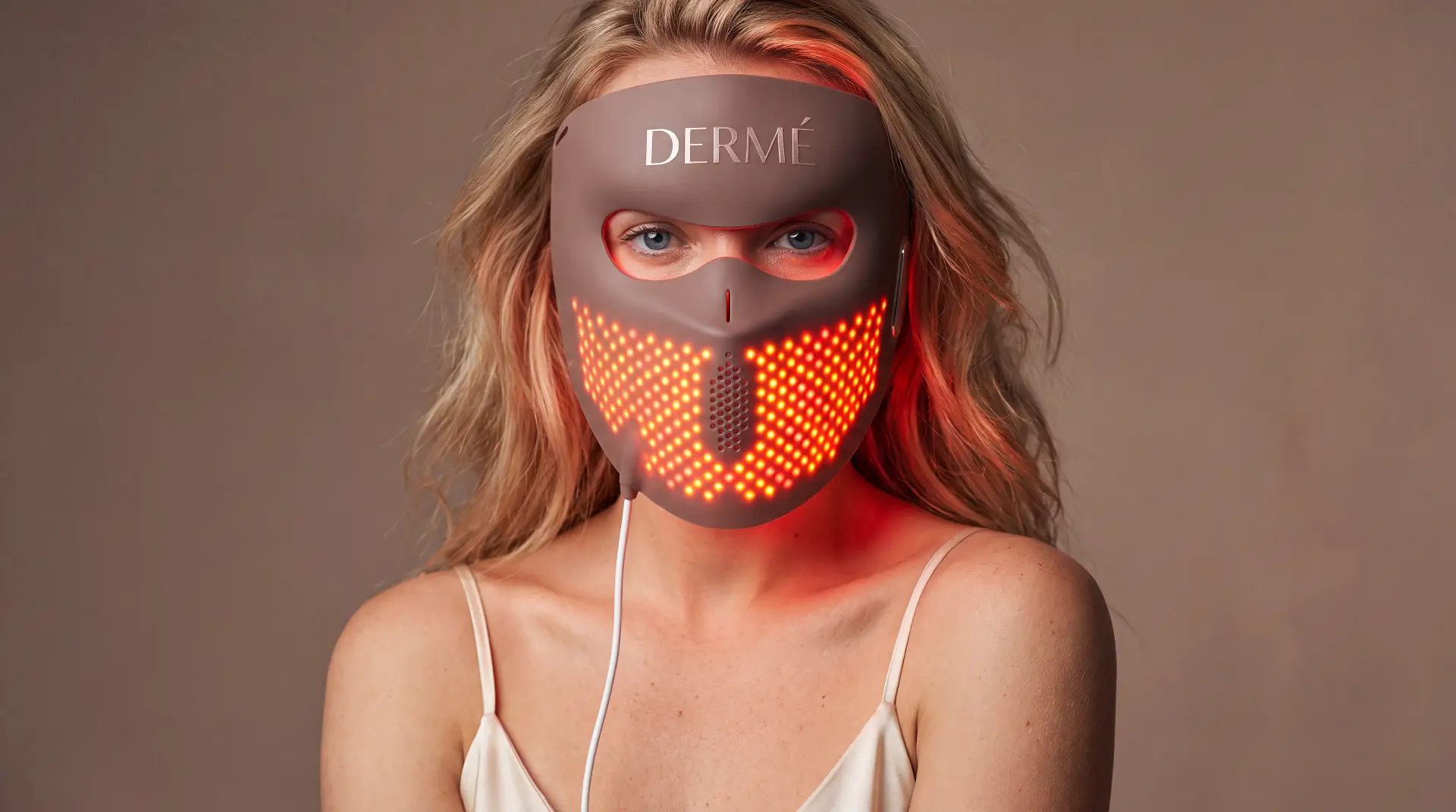 Model wearing the Dermé G11 laser face mask during a session